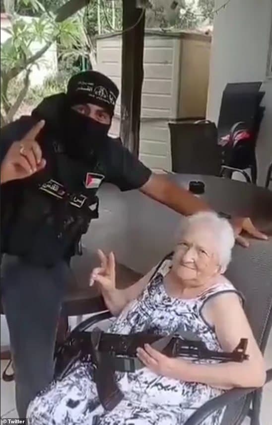 Hamas fighters cruelly coerced an elderly Israeli woman into clutching a machine gun