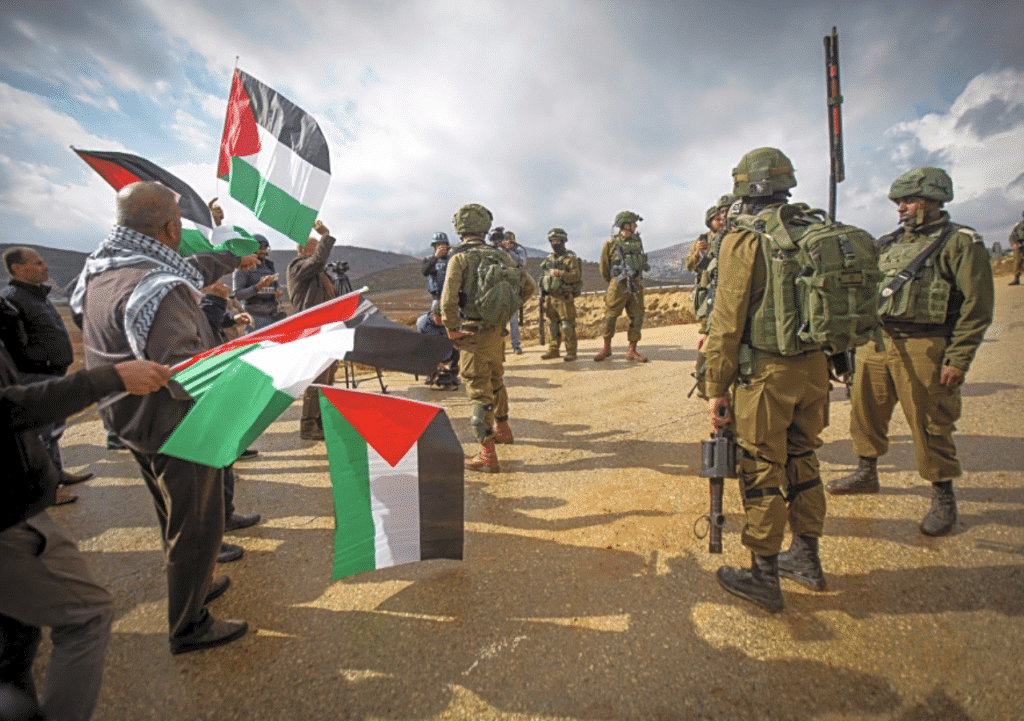 Israeli soldiers stand guard during a Palestinian protest near the Jewish settlement of Elon Moreh,east of Nablus, in the West Bank, November 25, 2022