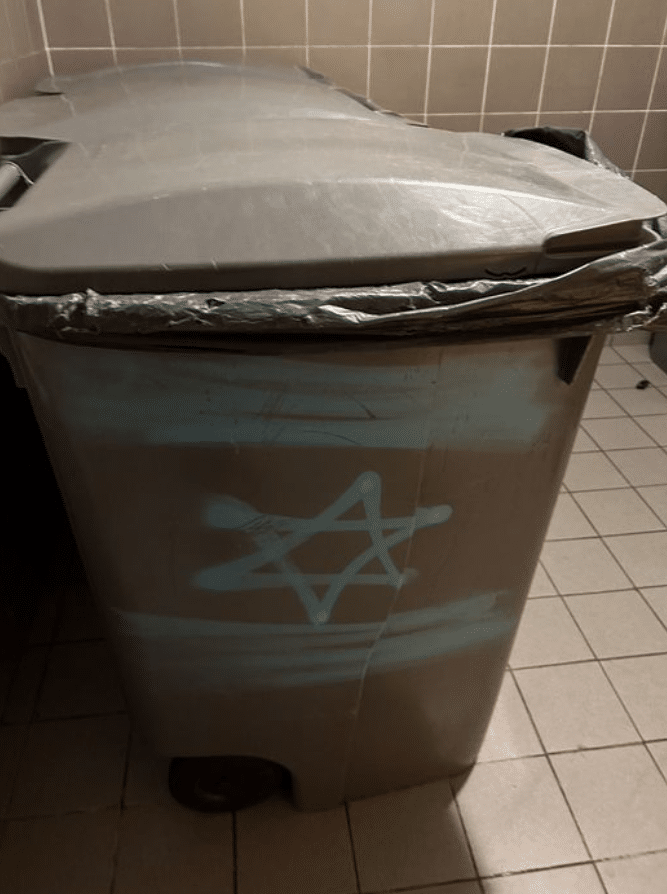 In Paris on 1st of November, Israeli flag and Star of David spray painted on garbage cans in the garbage room of a residential living area.